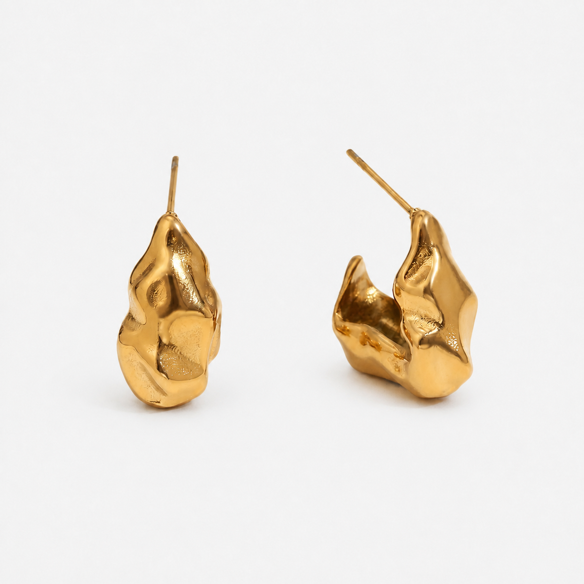 Molten Muse gold-coloured sculptural stud pair photographed alone with irregular polished surfaces