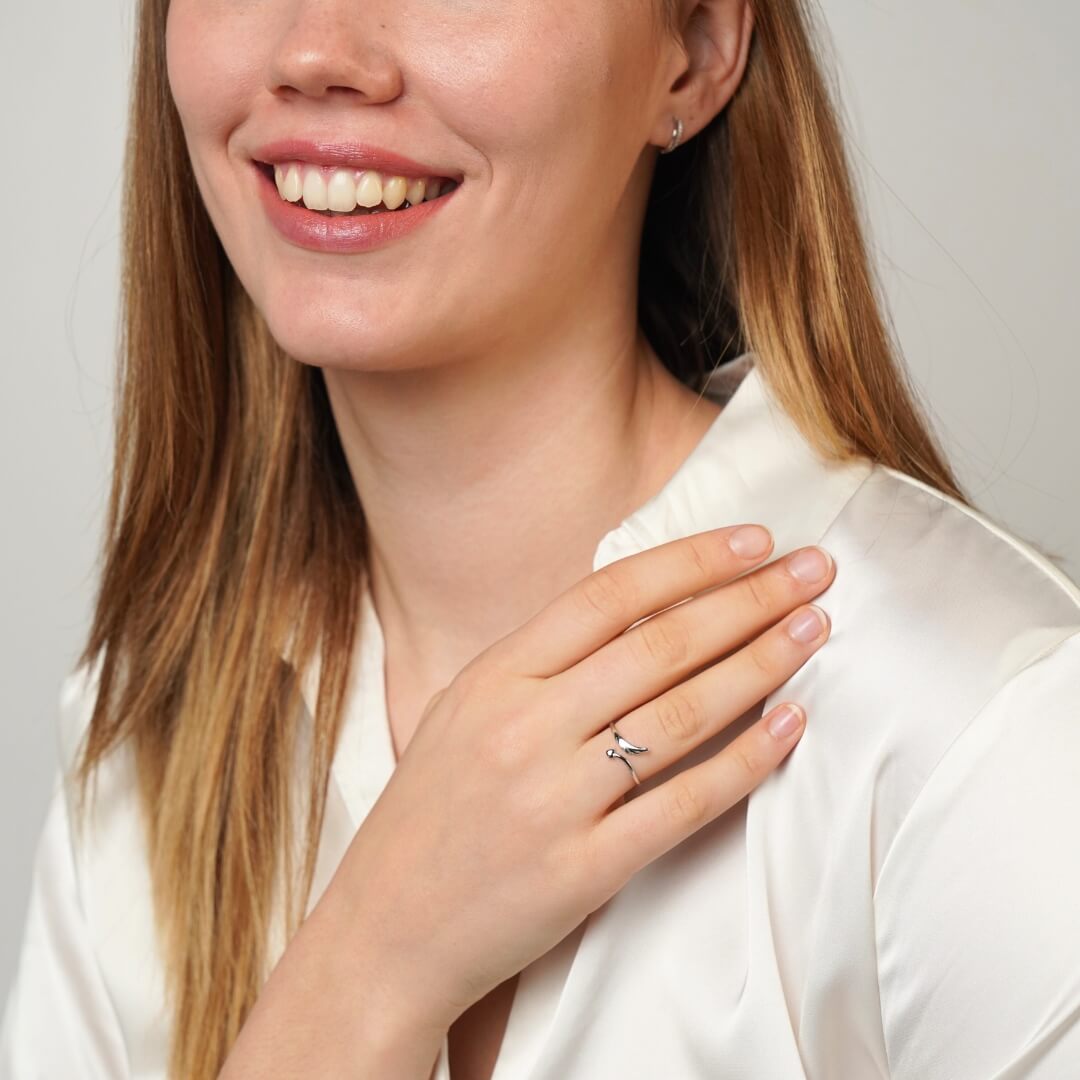 Close-up of gold feather heart ring detail