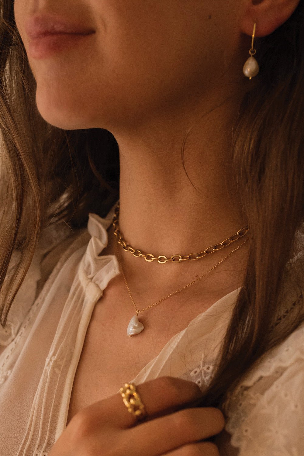 18K gold pearl hoop earrings shown with secure latch closure