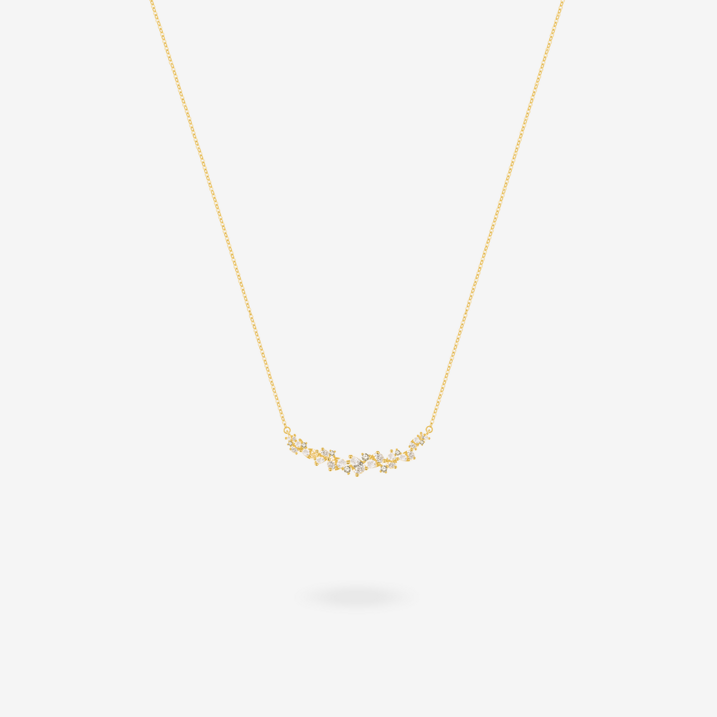 Wisteria bar necklace shown layered with other delicate chains