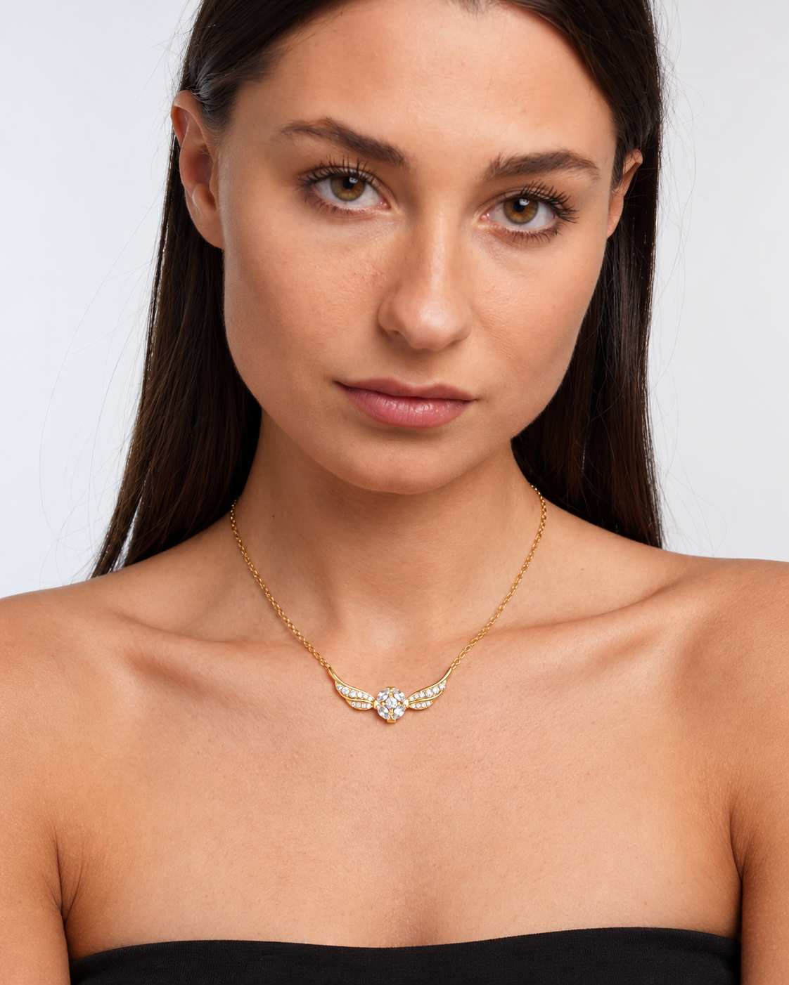 Golden Snitch Winged Pendant Necklace in gold worn by a model, portrait