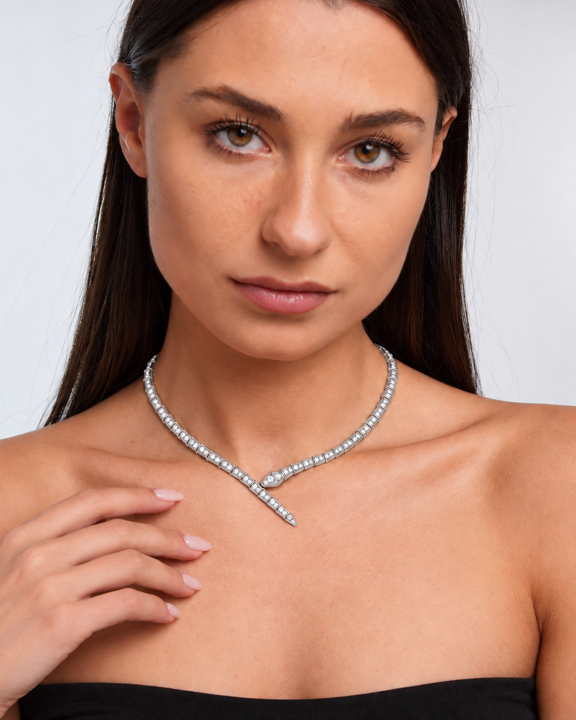 Crystal serpent choker necklace with articulated links and crossed front ends in a silver finish worn by the model.