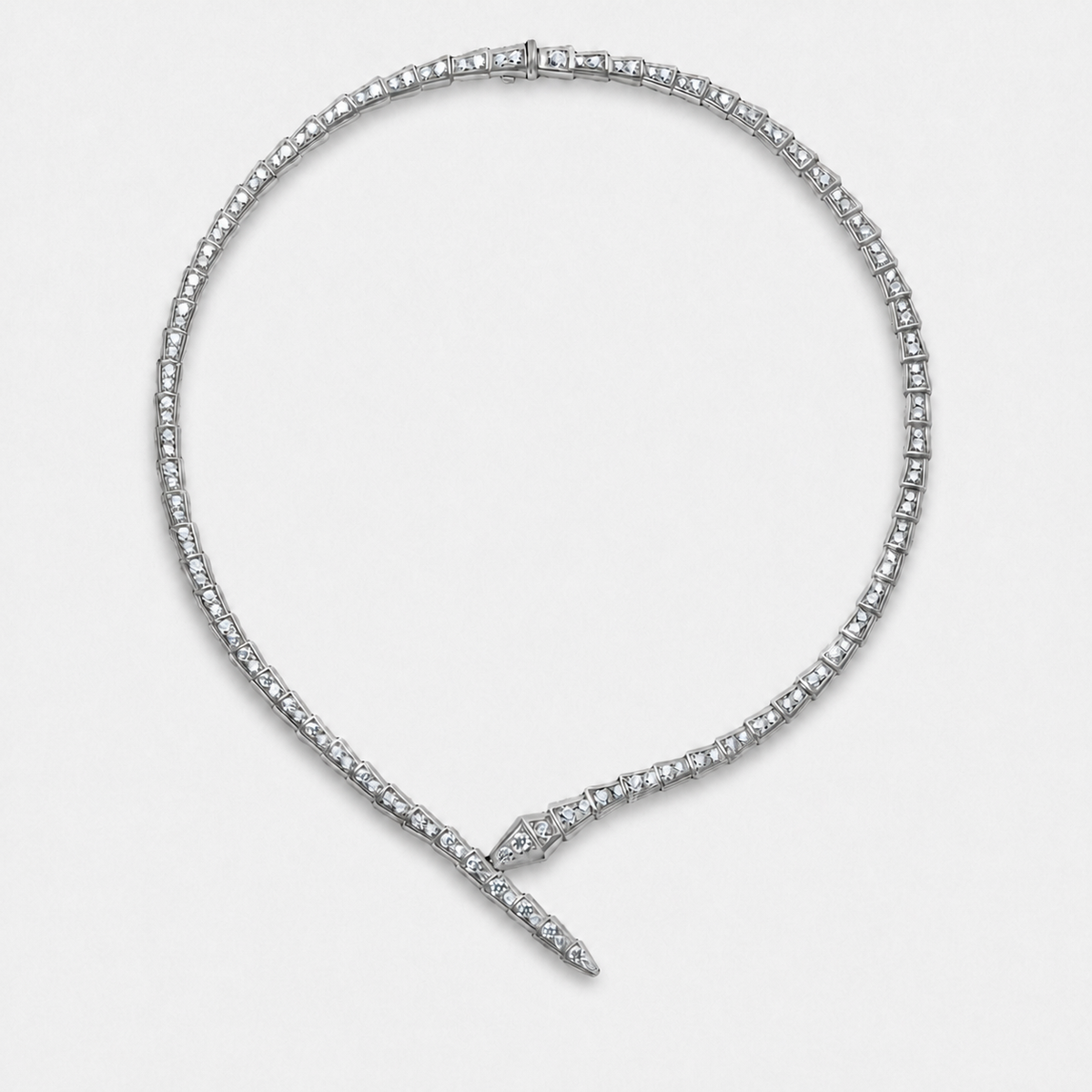 Crystal serpent choker necklace with articulated links and crossed front ends in a silver finish on a neutral off-white background.