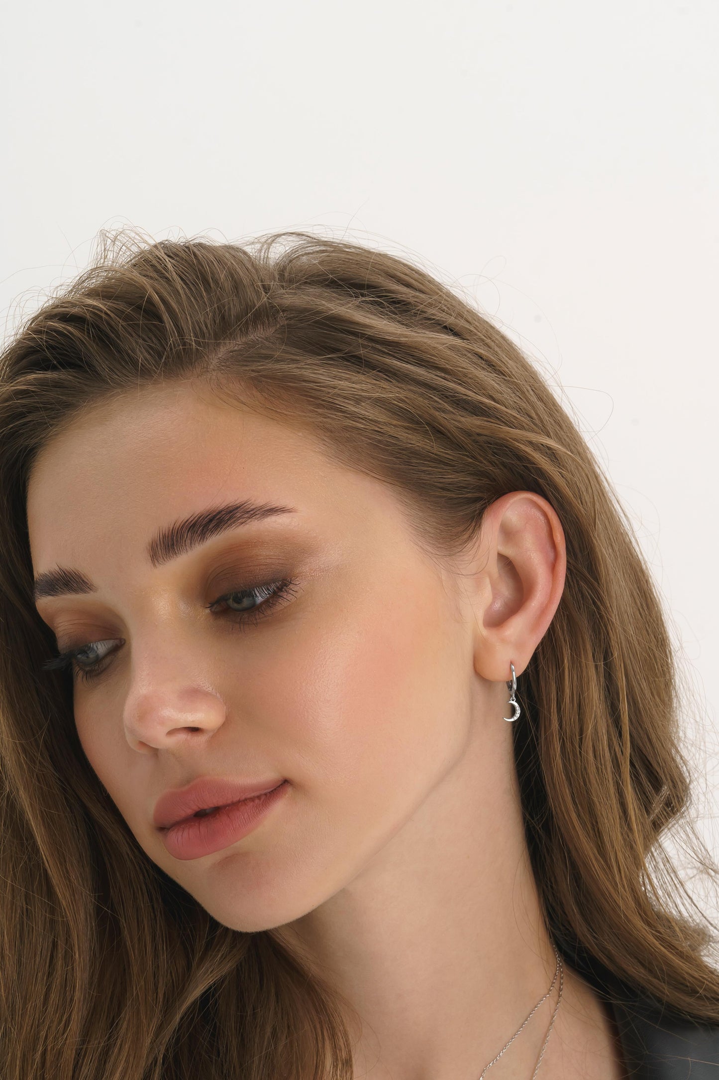 Close-up of sterling silver star moon earring detail
