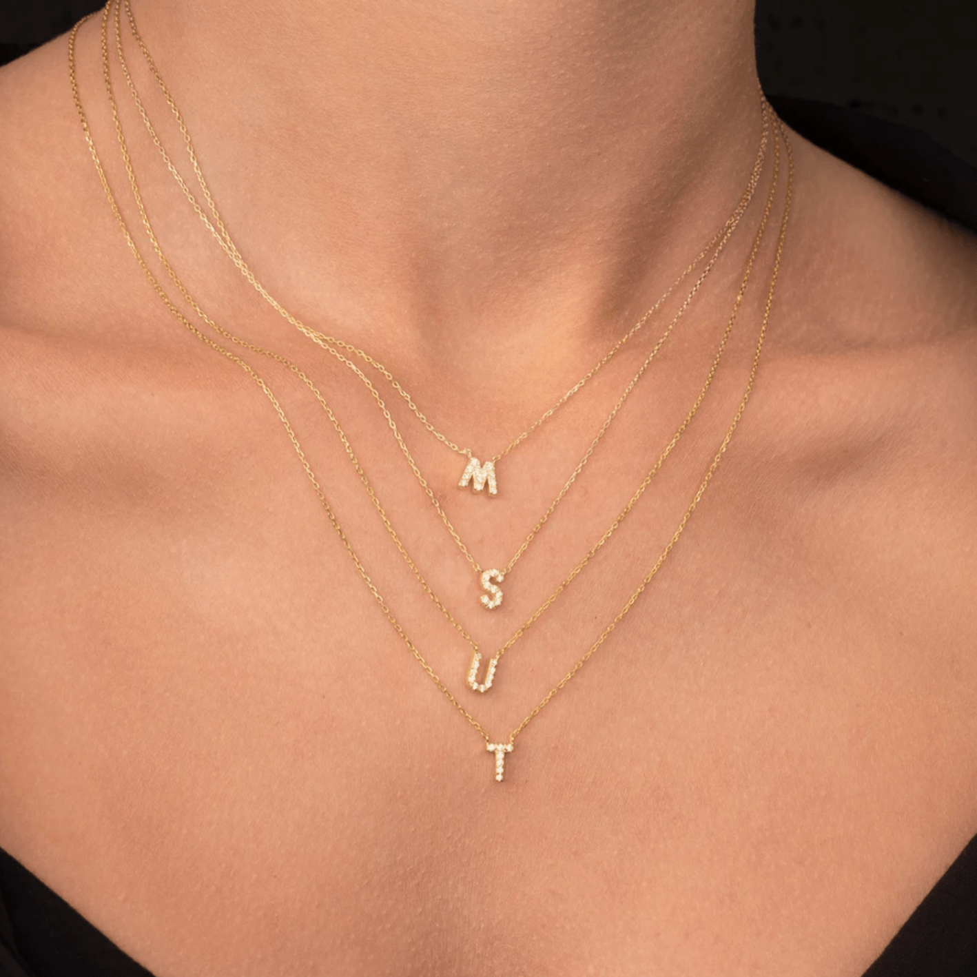 Sapphire initial necklace lifestyle shot, layered look