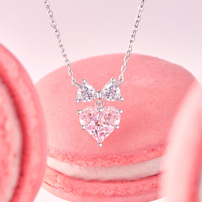 Bow and heart sterling silver necklace, side angle view