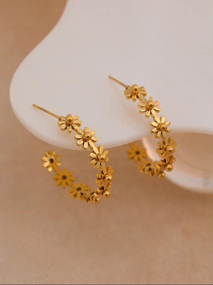Close-up of gold floral wreath hoop earring