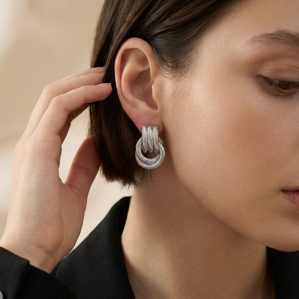 Sculptural gold knot drop earrings — side angle