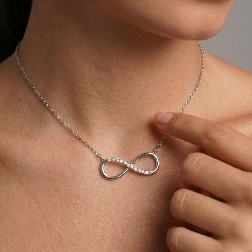 Close-up of silver infinity love pendant detail