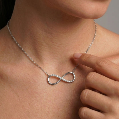 Close-up of silver infinity love pendant detail