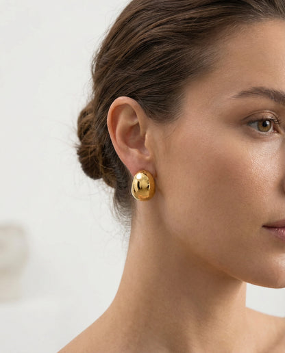 Close-up of polished crescent dome earring — 18K gold finish