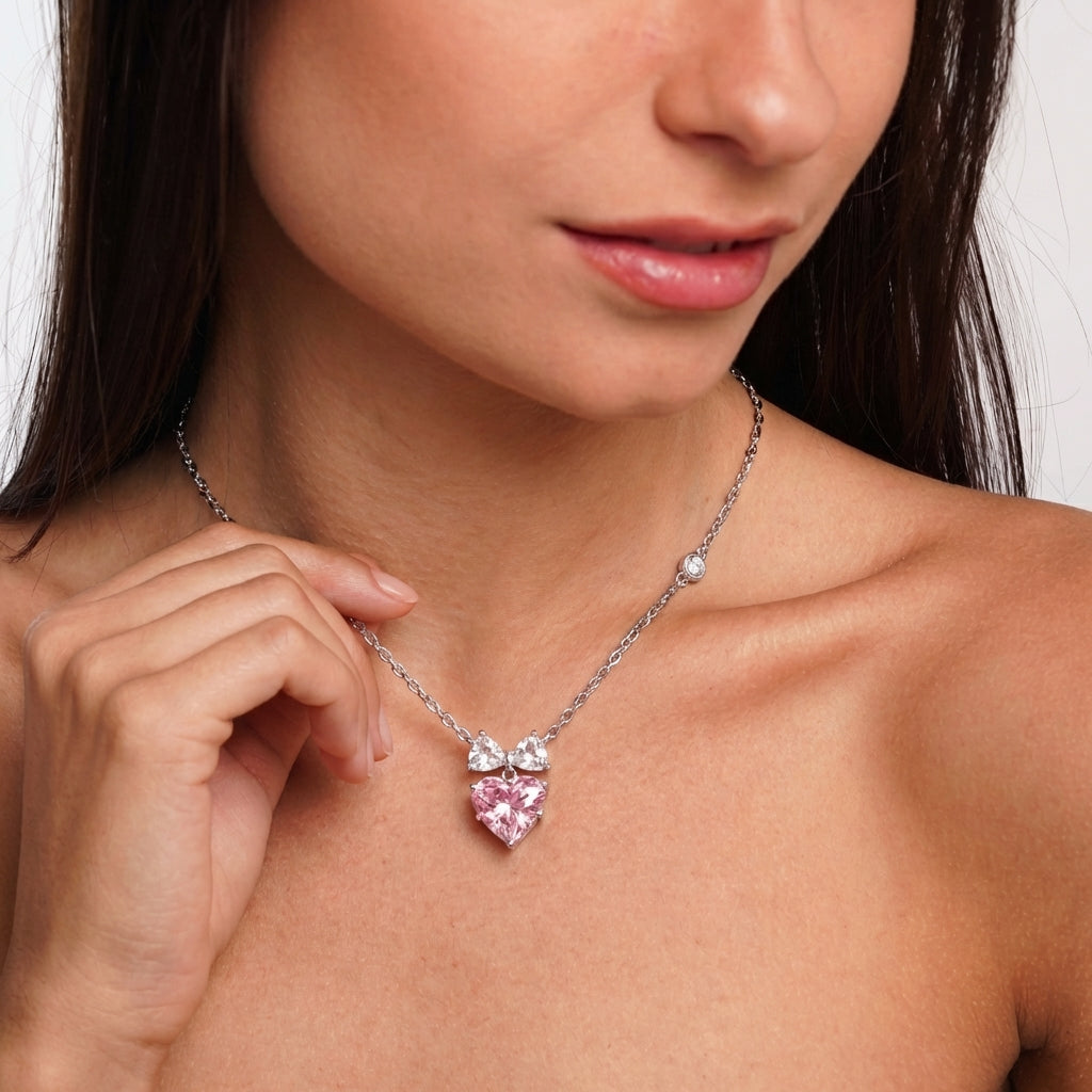 Close-up of silver bow heart pendant detail