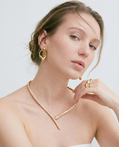 Gold serpent choker necklace styled on a feminine neckline