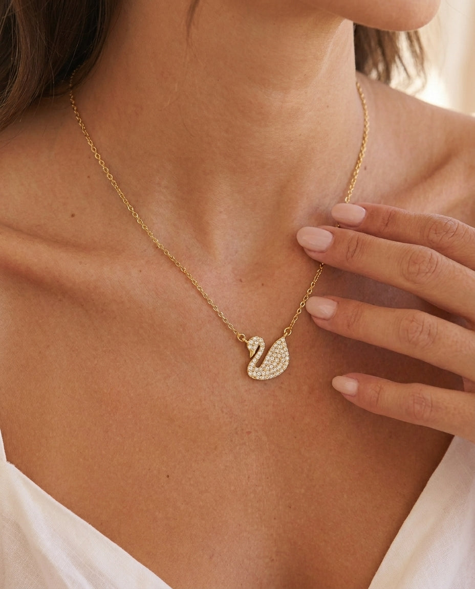 Ravyena Geneviève swan necklace — sculptural gold swan pendant with white zircon