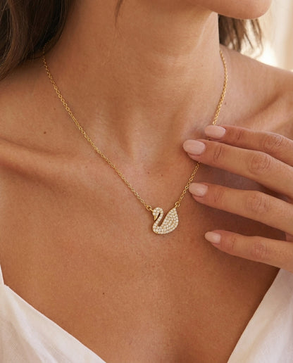 Ravyena Geneviève swan necklace — sculptural gold swan pendant with white zircon