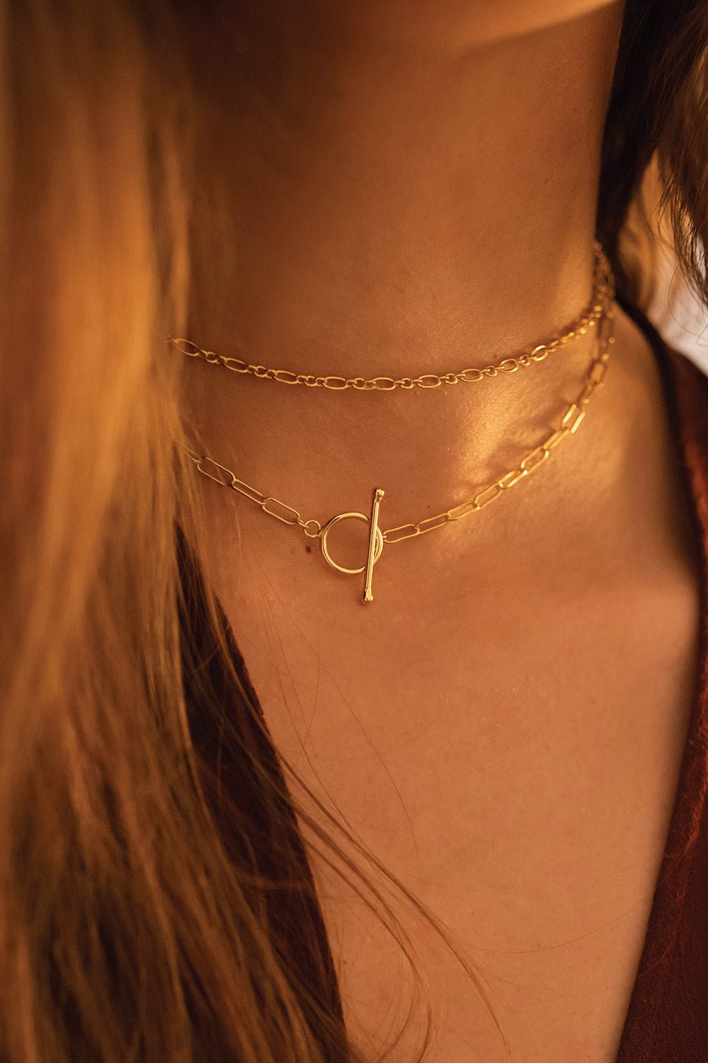 Gold chain choker styled on a feminine neckline