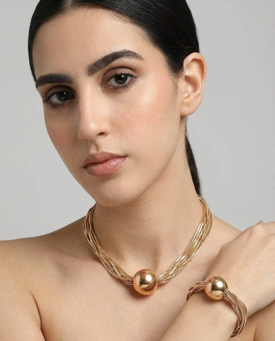 Elegant multi-strand gold necklace with ball pendant