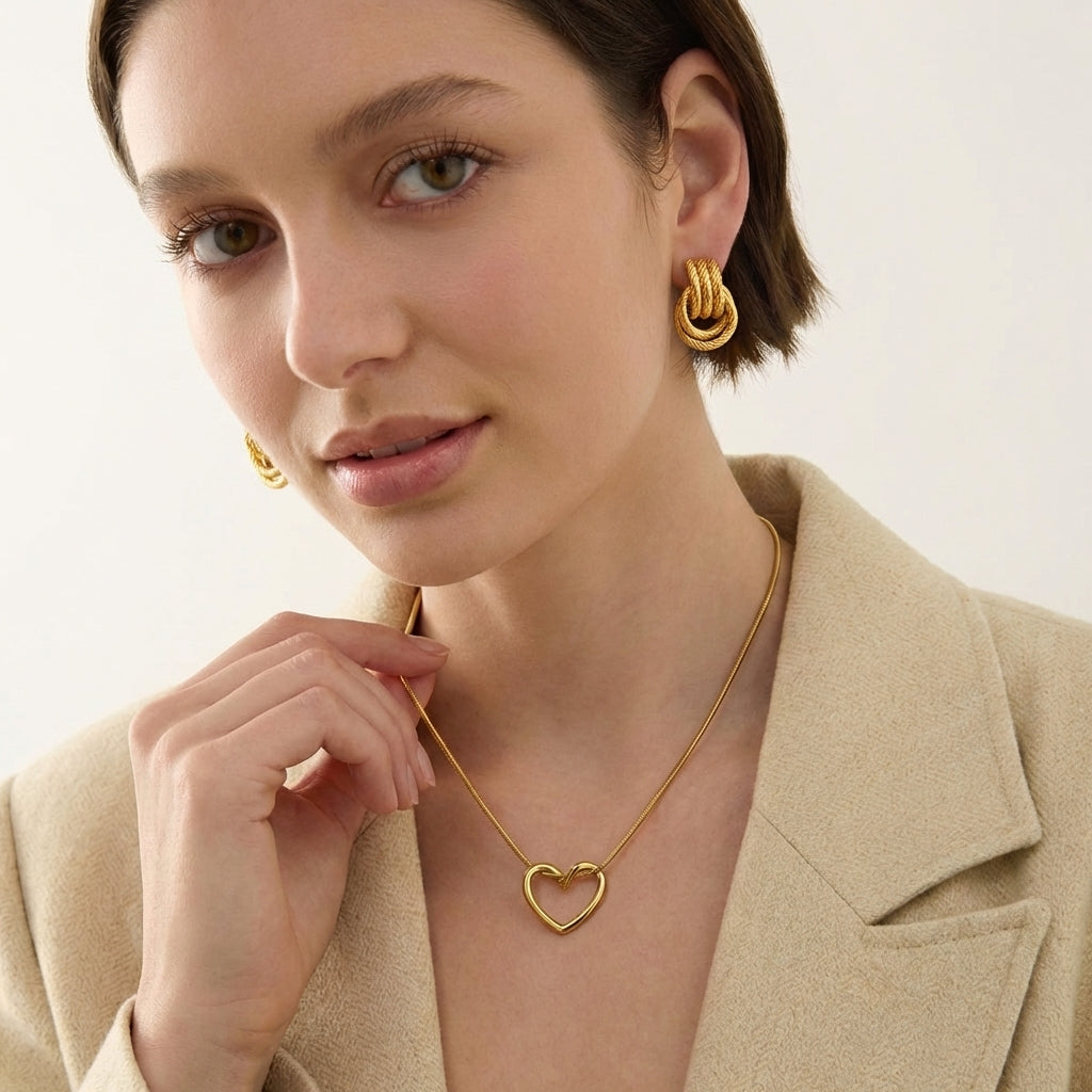 Gold sculptural knot earrings — top-down close-up view