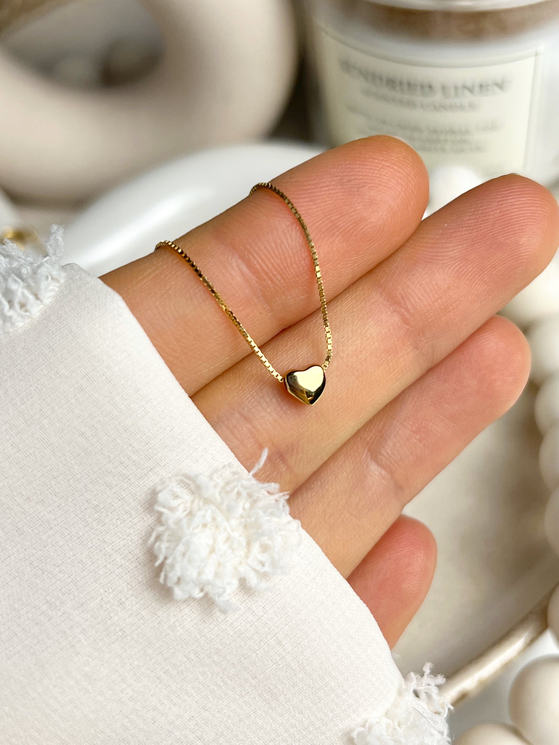 Delicate gold heart pendant on fine chain