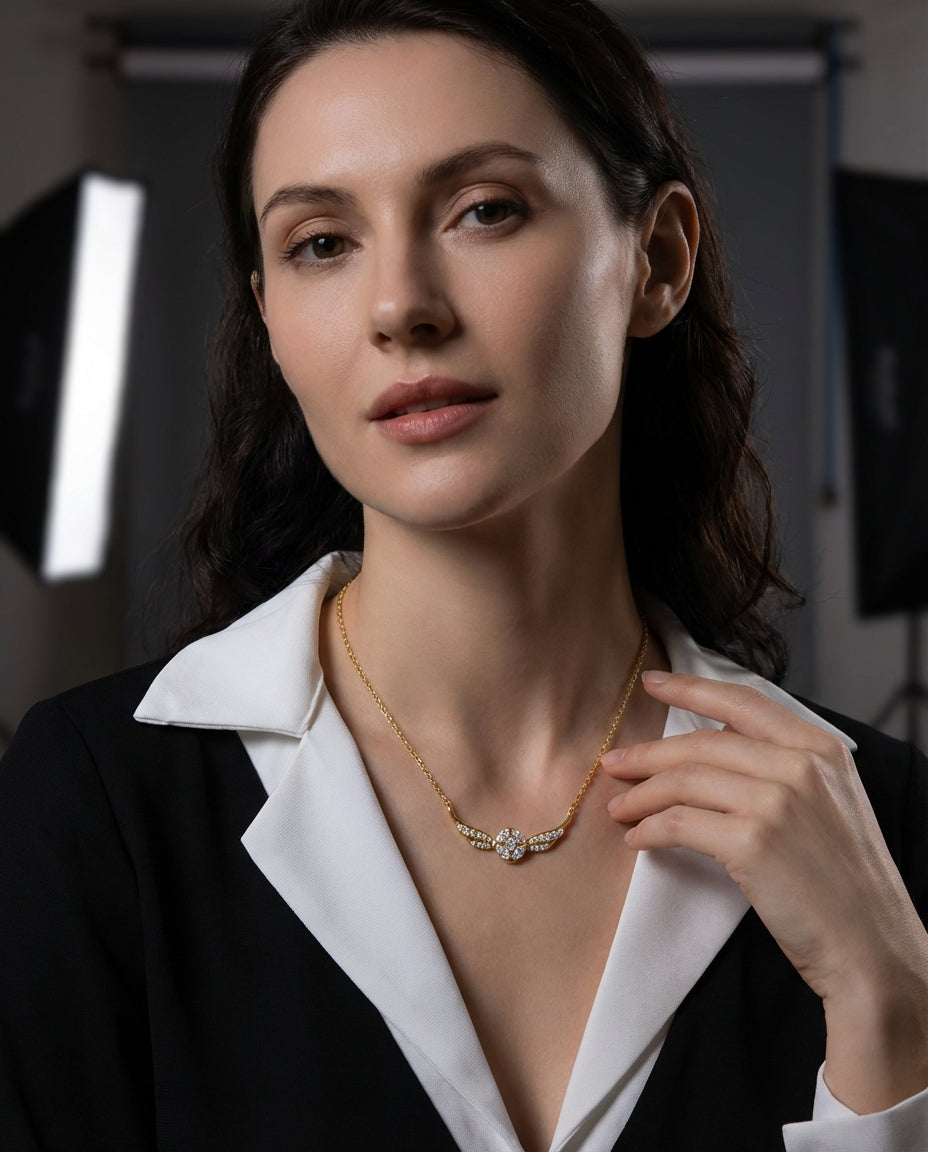 Close-up of sterling silver winged pendant with cubic zirconia stone detail