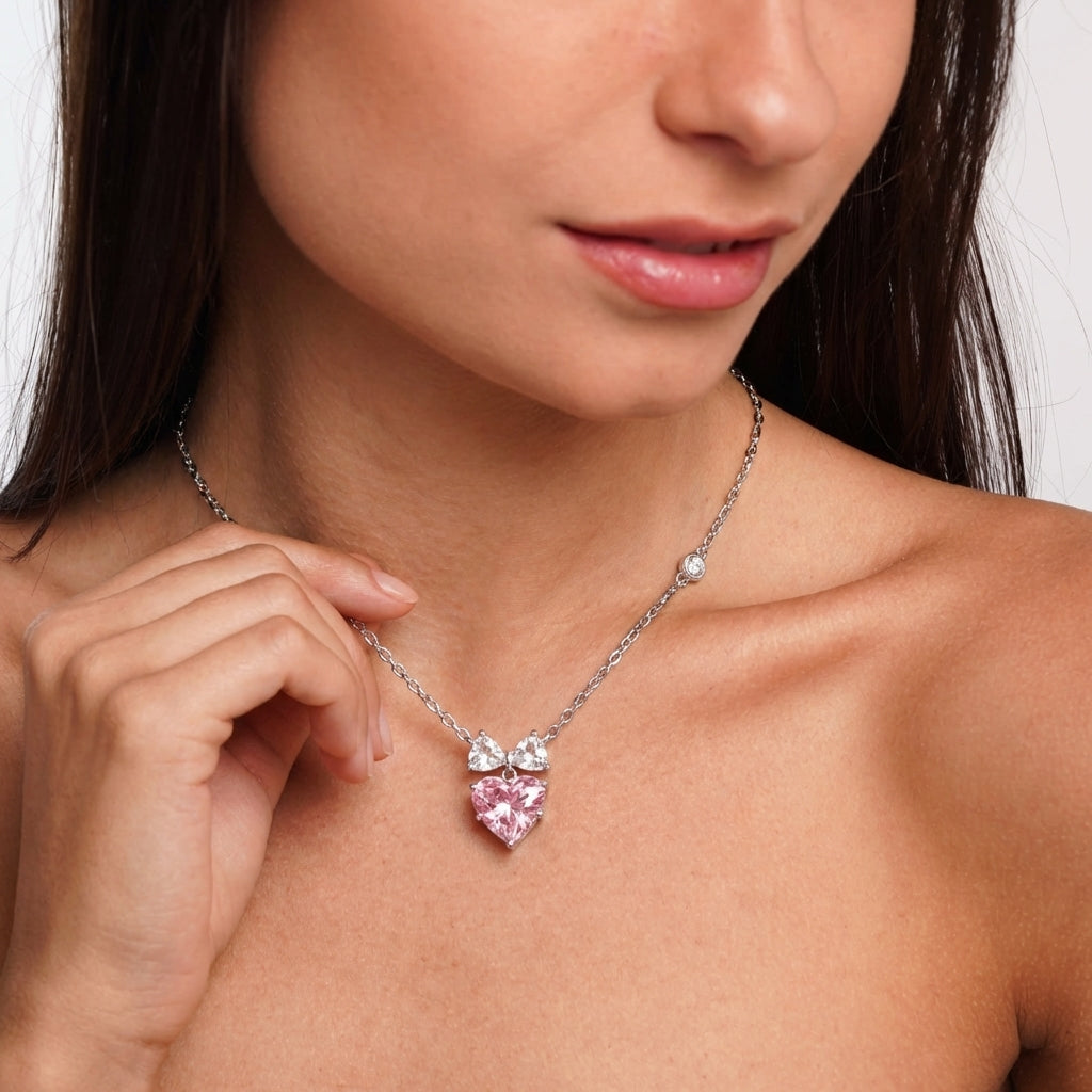 Bow heart necklace styled on a model's neckline