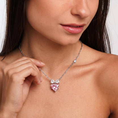 Bow heart necklace styled on a model's neckline