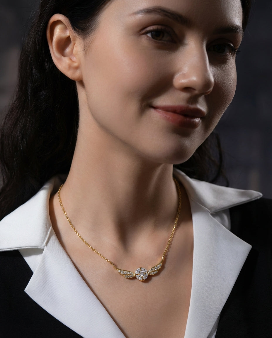 Golden snitch necklace styled on model collarbone sterling silver