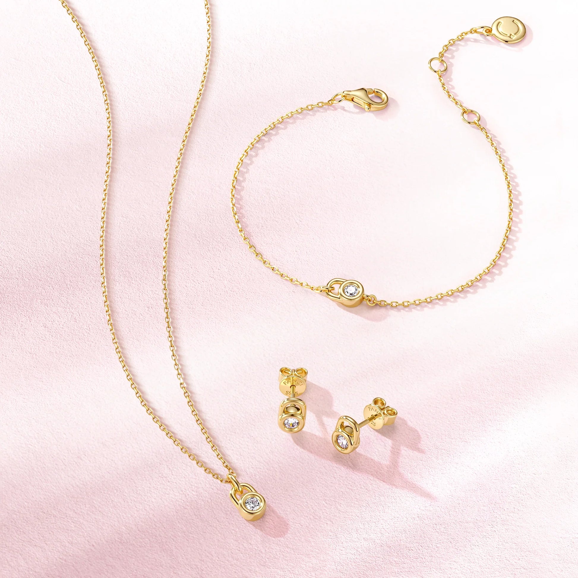 Silver lock pendant bracelet layered with finer chains for everyday wear
