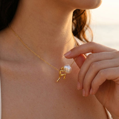 Sisyphus necklace shown with elegant outfit
