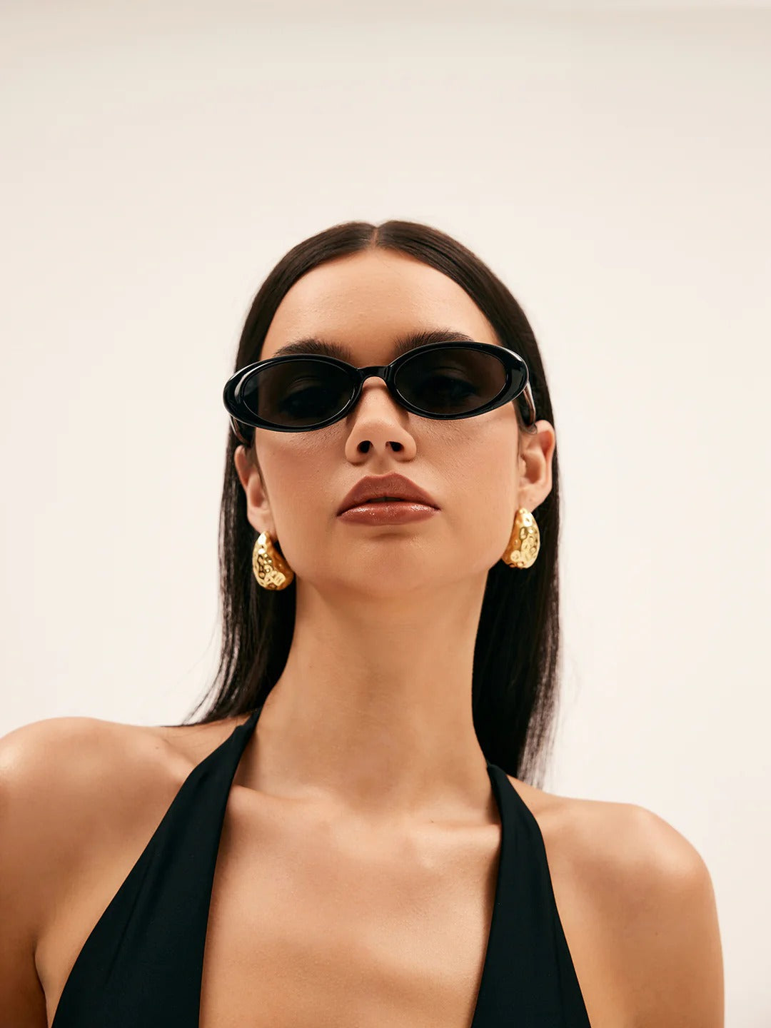 Hammered earrings styled on a model's ear