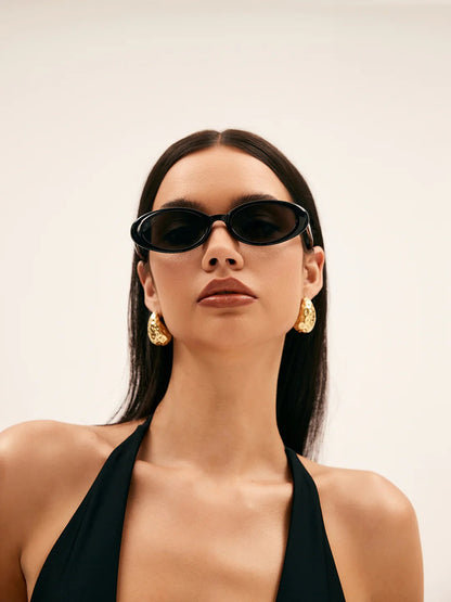 Hammered earrings styled on a model's ear
