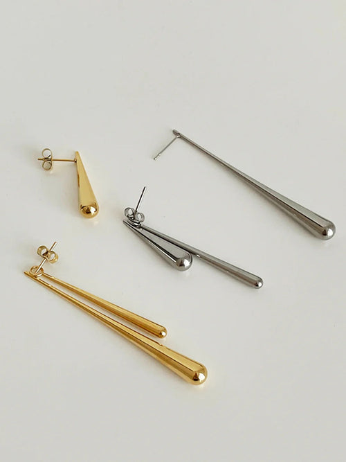 Asymmetrical water drop earrings in gold by Ravyena