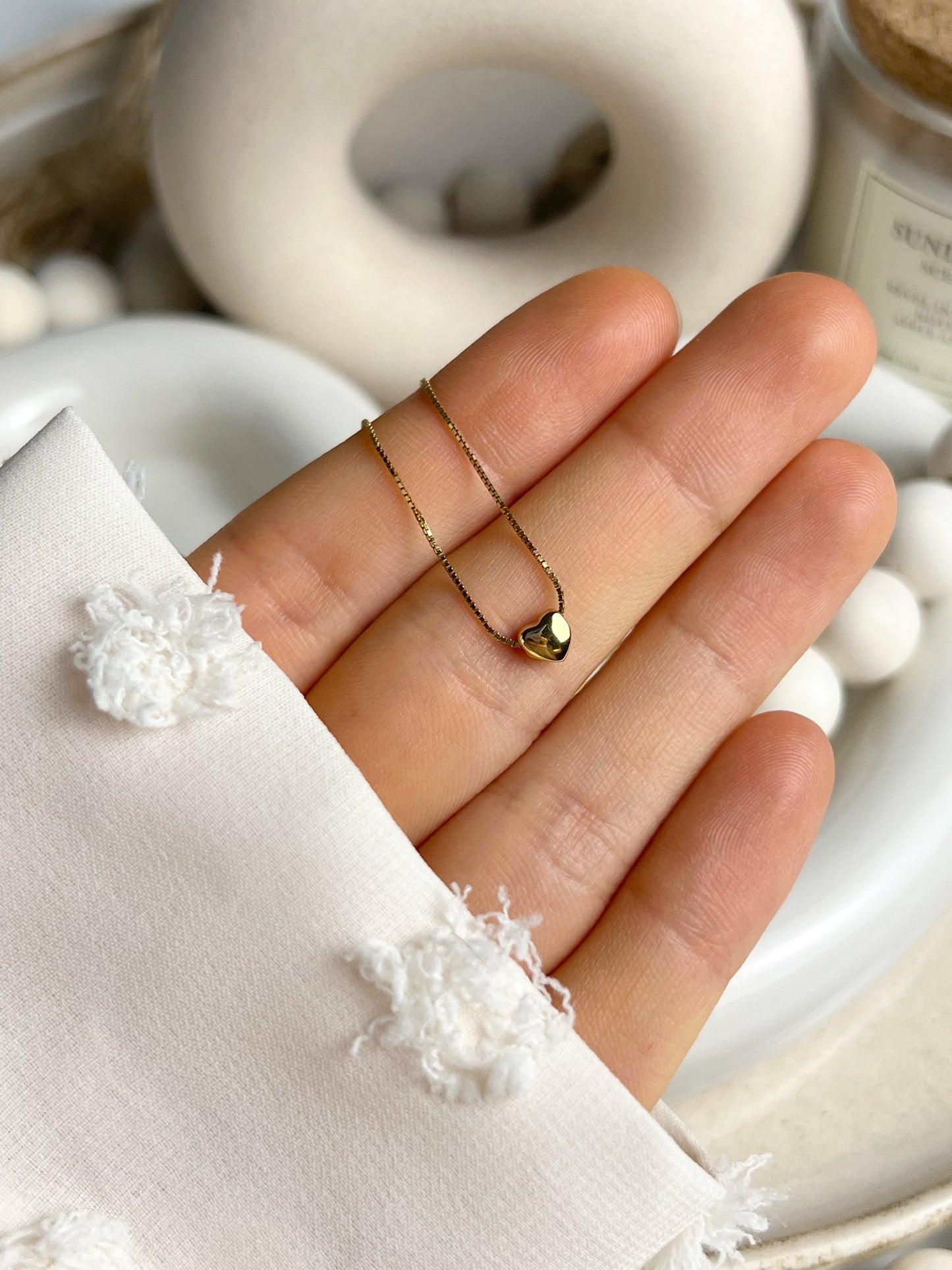 Petite heart necklace shown with elegant outfit