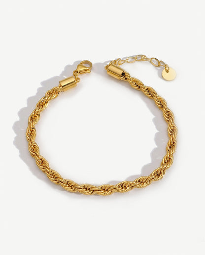 14K gold twisted rope chain bracelet on a neutral backdrop