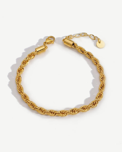 14K gold twisted rope chain bracelet on a neutral backdrop