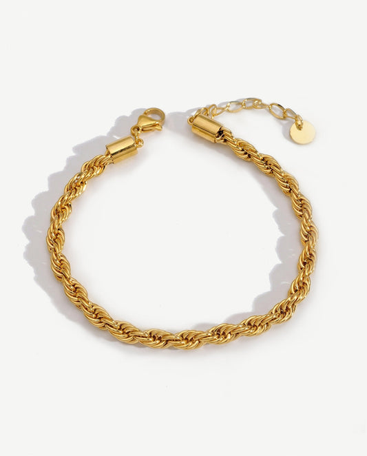 14K gold twisted rope chain bracelet on a neutral backdrop