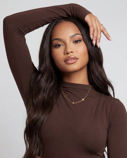Lucky clover gold choker styled on a model's neckline
