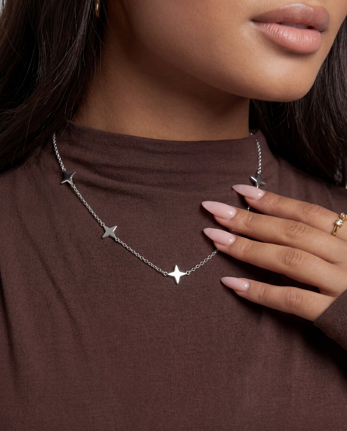Sterling silver clover choker styled on a model's neckline