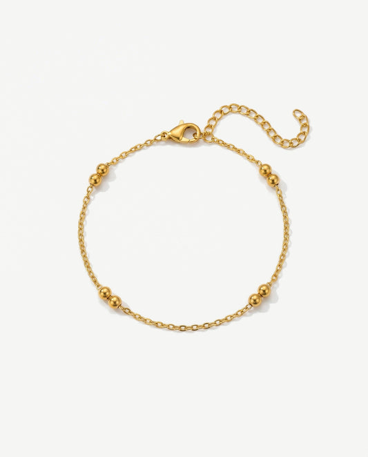 Delicate 14K gold double beaded satellite chain bracelet on a feminine wrist