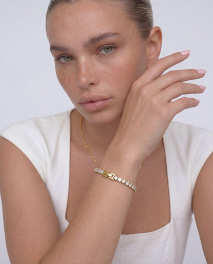 Close-up of gold tennis bracelet, continuous line of cubic zirconia