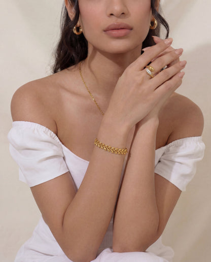 Gold leaf bracelet styled with matching leaf necklace