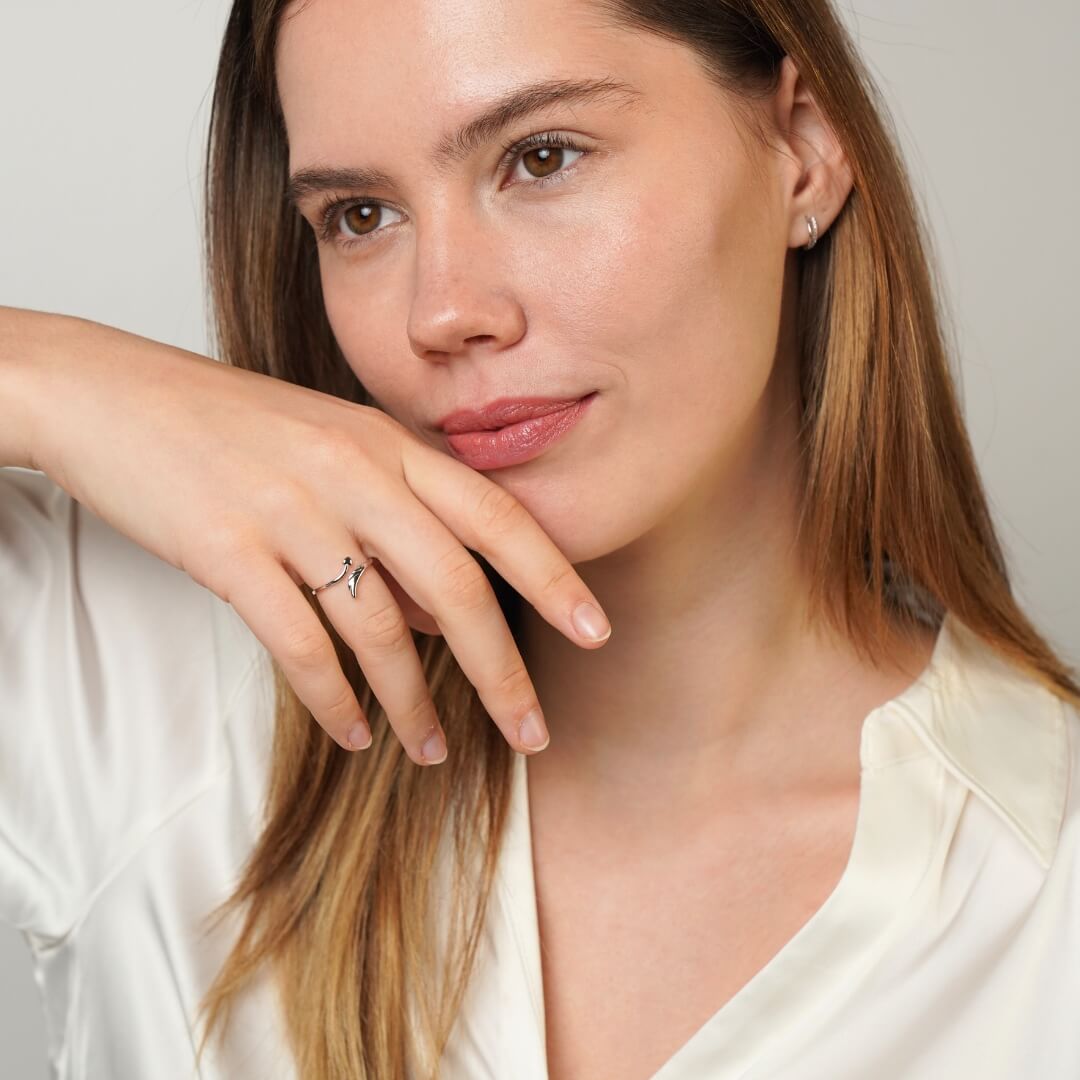 Feather heart ring styled on a feminine hand