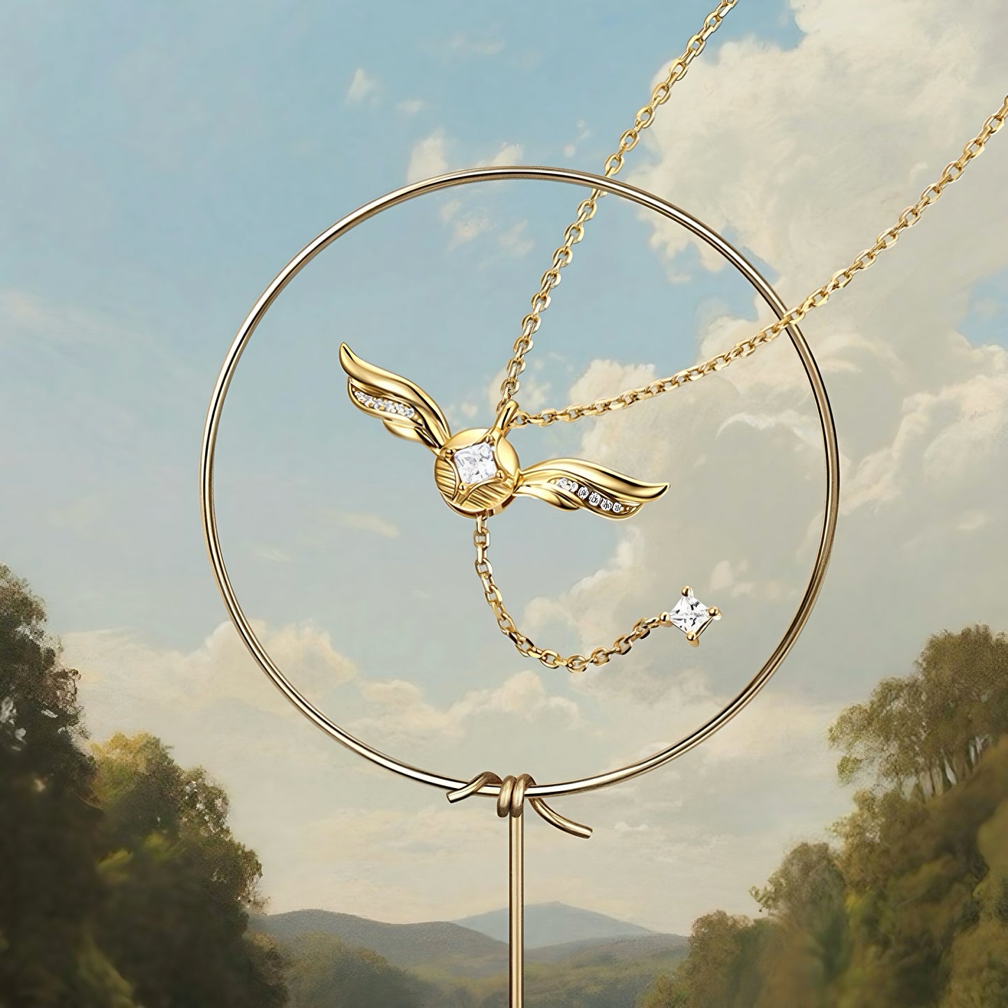 Close-up of winged cubic zirconia pendant on gold-plated lariat necklace
