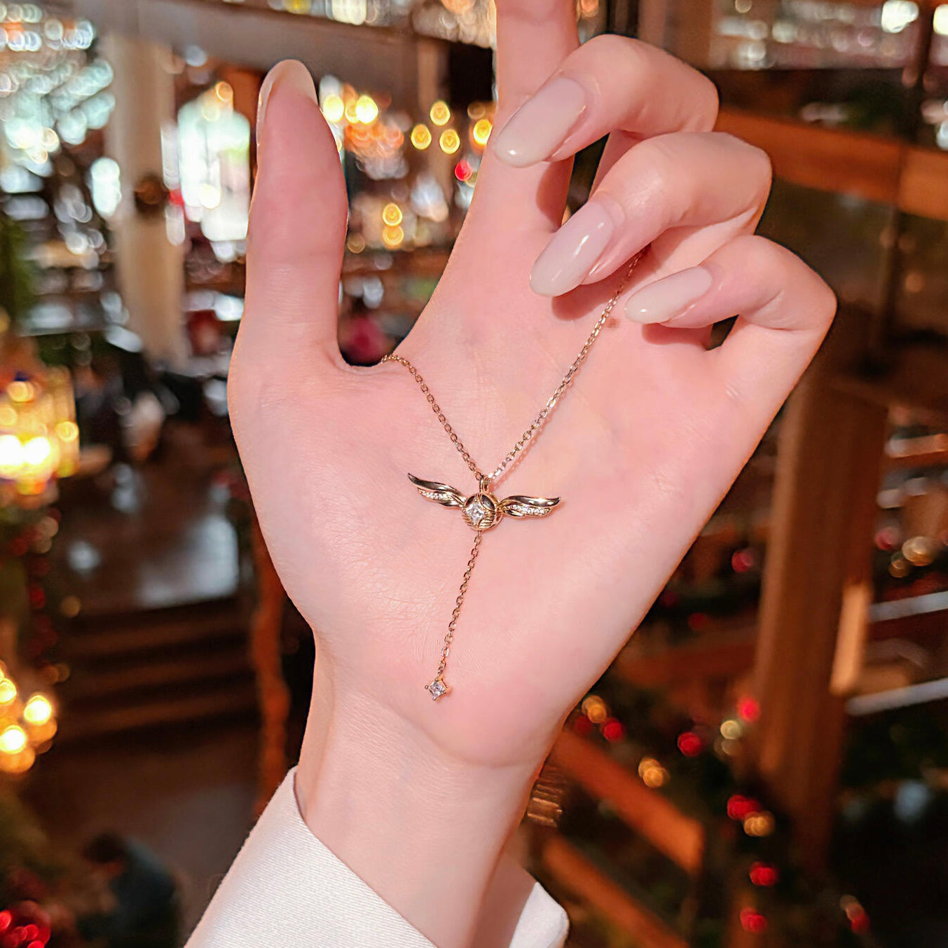 Gold-plated lariat necklace with cubic zirconia drop pendant, close-up