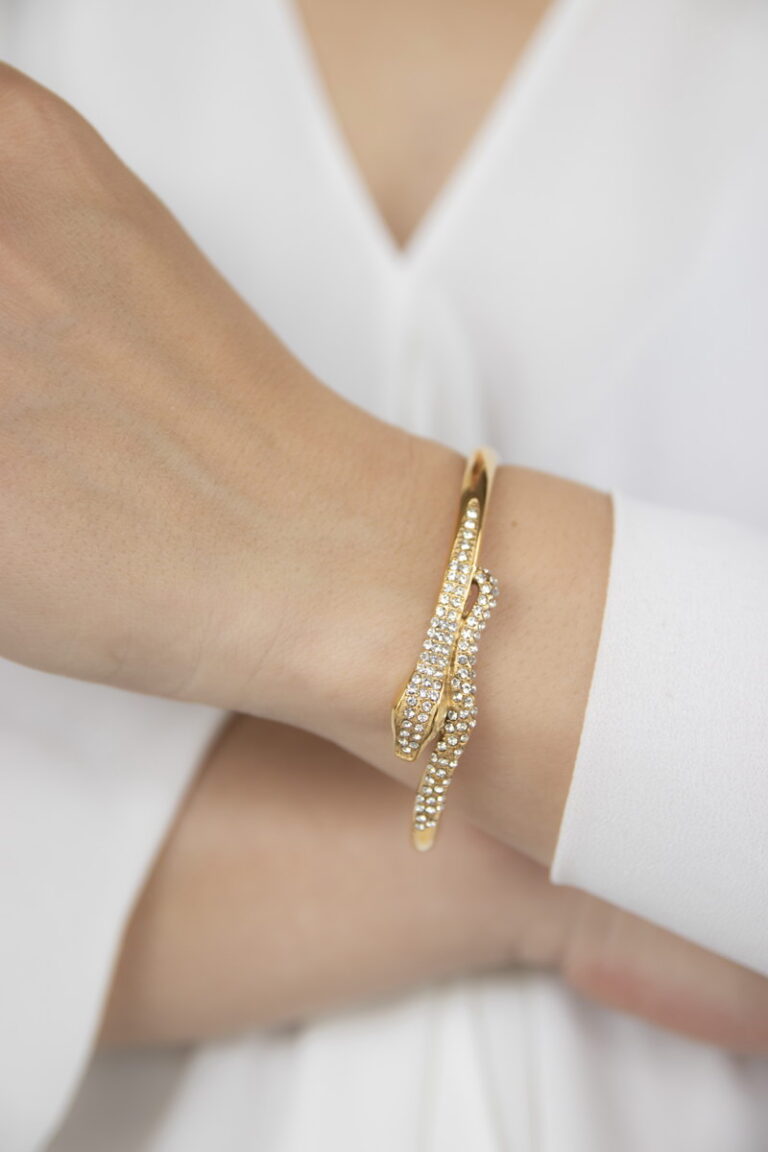 Modern gold twisted cuff bracelet styled with a neutral outfit