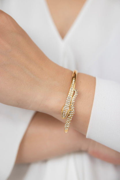 Modern gold twisted cuff bracelet styled with a neutral outfit