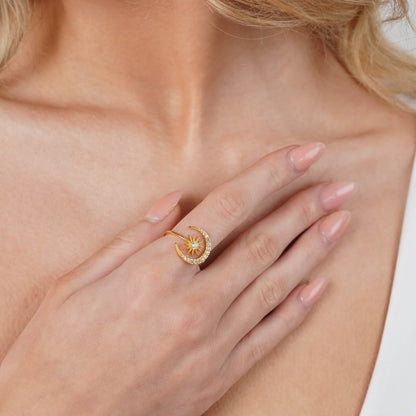 Sun and moon ring styled on a feminine hand
