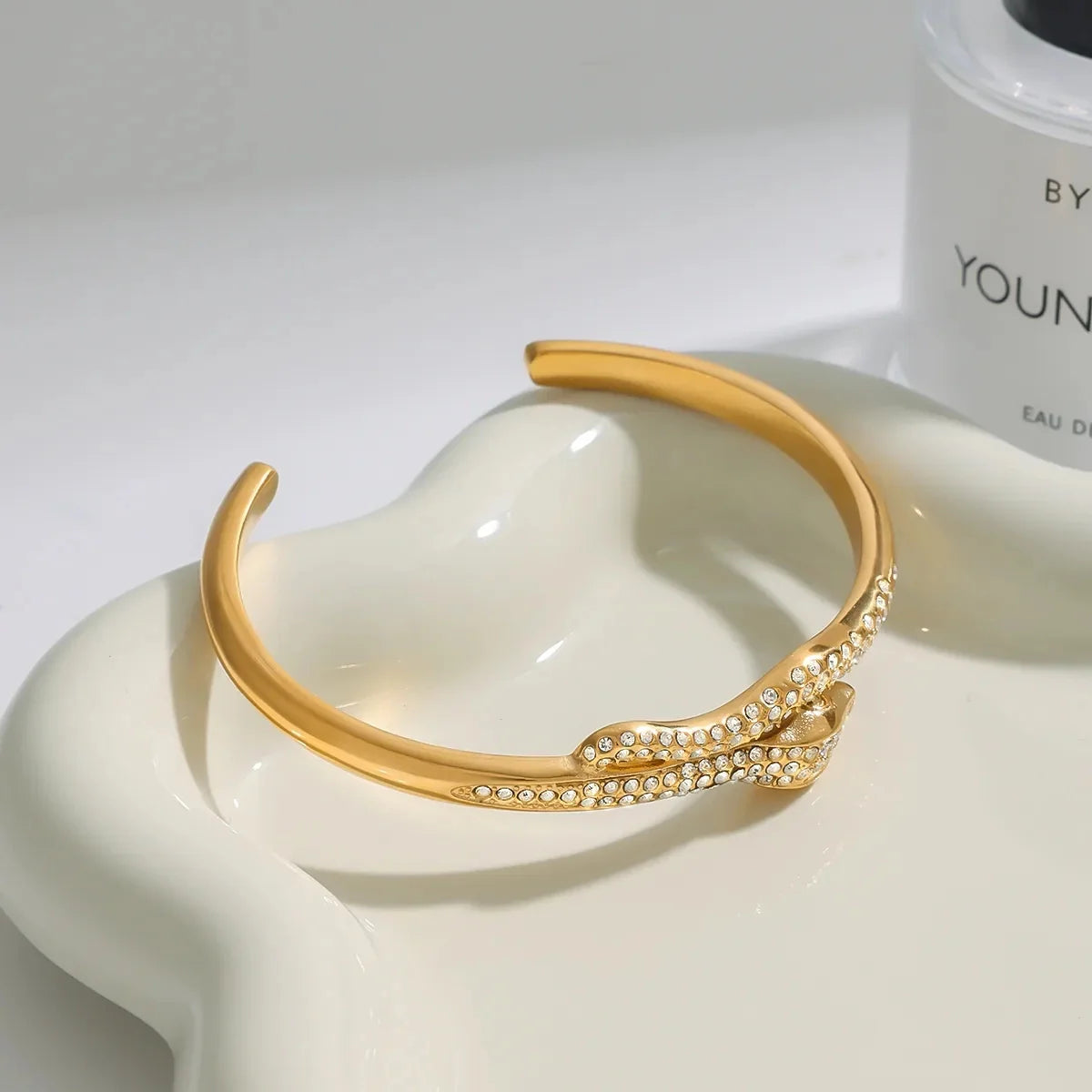 Detail of gold twisted cuff bracelet showing micro crystal accents