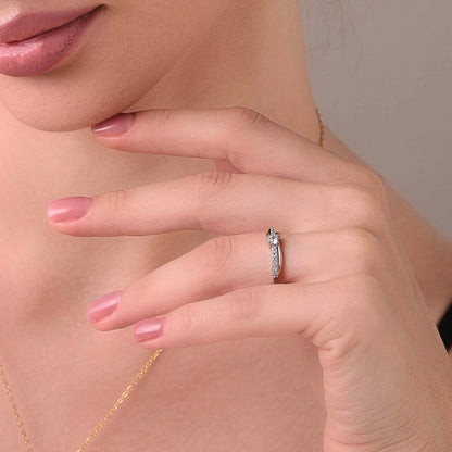 Ups and downs ring styled on a feminine hand