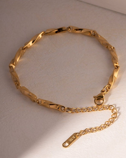 Close-up of polished gold twist bracelet detail